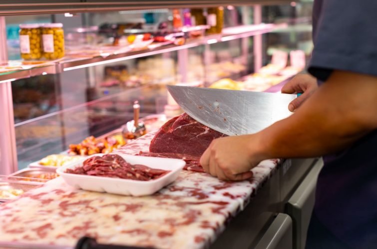 CARNICERO PREPARANDO BANDEJA DE CARNE